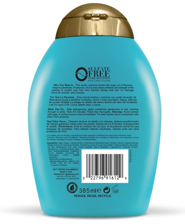 Une bouteille de shampoing OGX - Argan Oil of Morocco, 385 ml avec une étiquette dorée, infusée à l'huile d'argan du Maroc.