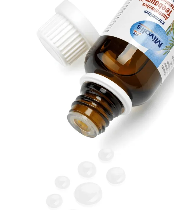 Une bouteille de Mivolis - Huile essentielle de l’arbre à thé avec un compte-gouttes sur le dessus, infusée à l’huile essentielle d’arbre à thé du Maroc.