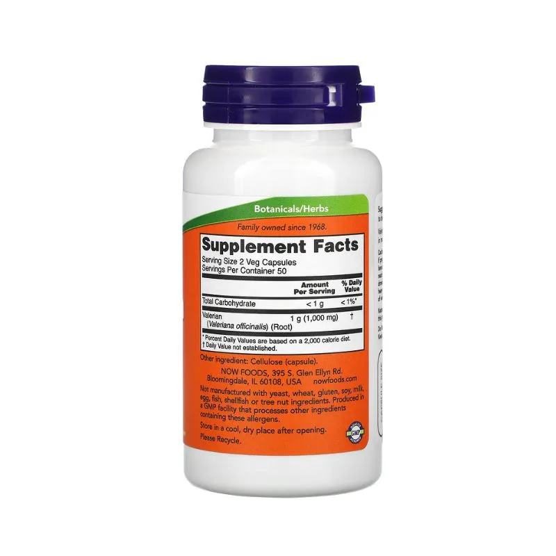 Bouteille blanche de NOW Foods Valerian Root 500 mg avec un bouchon violet, montrant l'étiquette du supplément et des ingrédients pour ce produit botanique, contenant 100 capsules végétales.